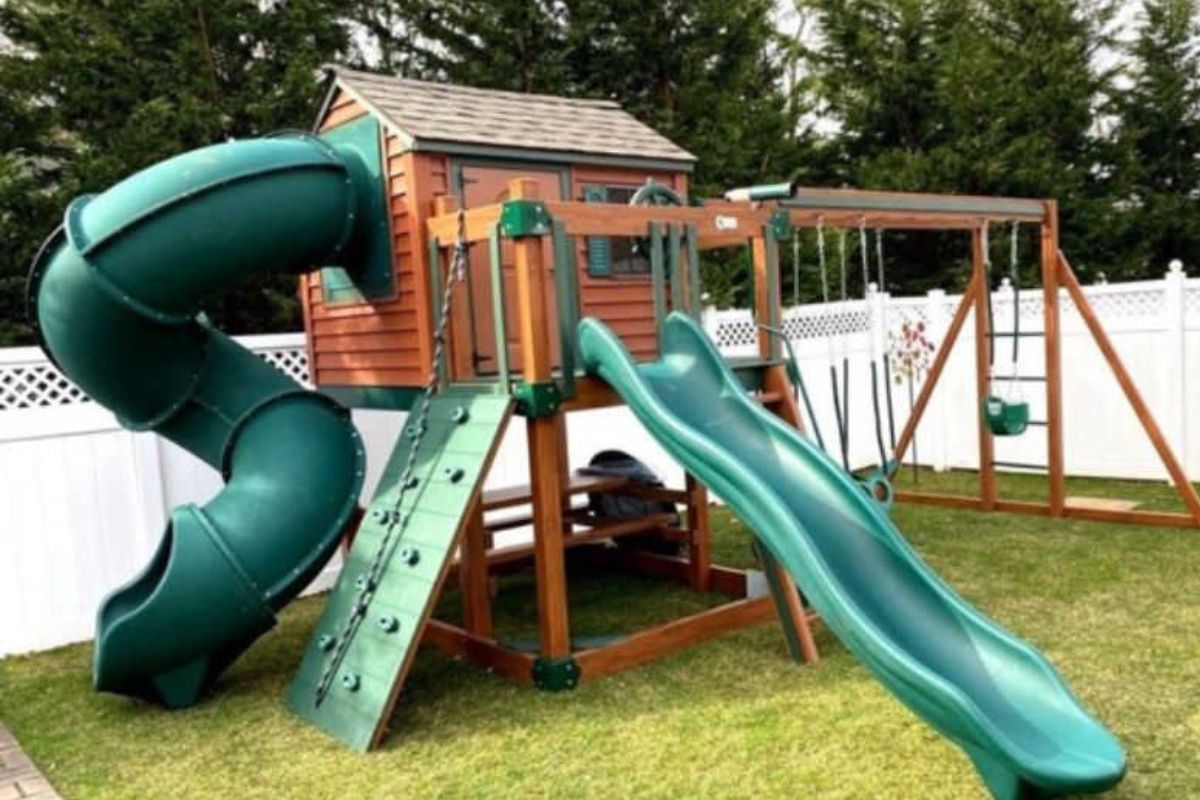 Kids Outdoor Playhouse In Wood grain and green in a yard