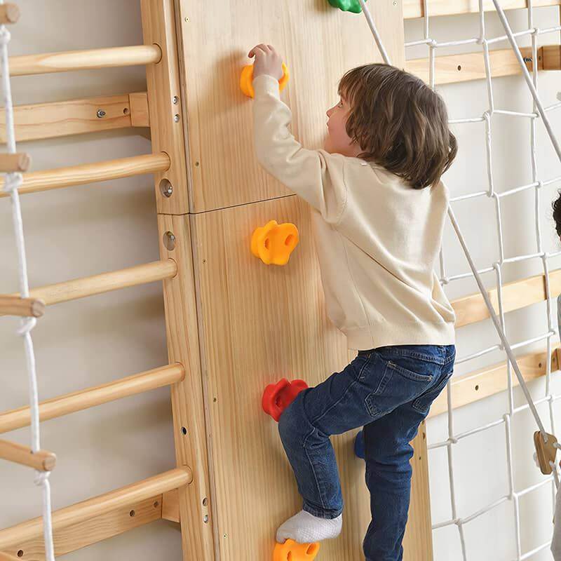 Avenlur Walnut - 9-in-1 Swedish Ladder Wall Gym Set Corner View Up Close Showing Kid Climbing The Rockwall