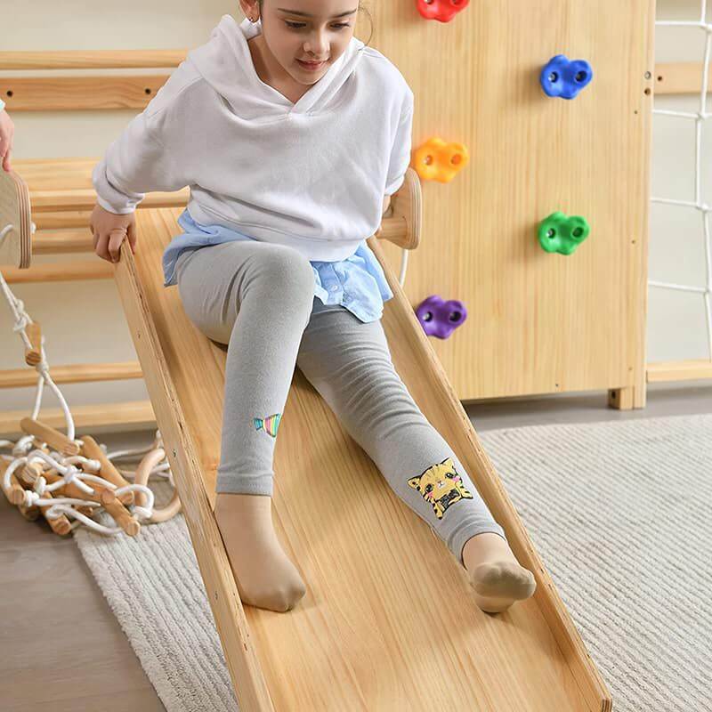 Avenlur Walnut - 9-in-1 Swedish Ladder Wall Gym Set Front View Showing A Girl Sliding Up Close
