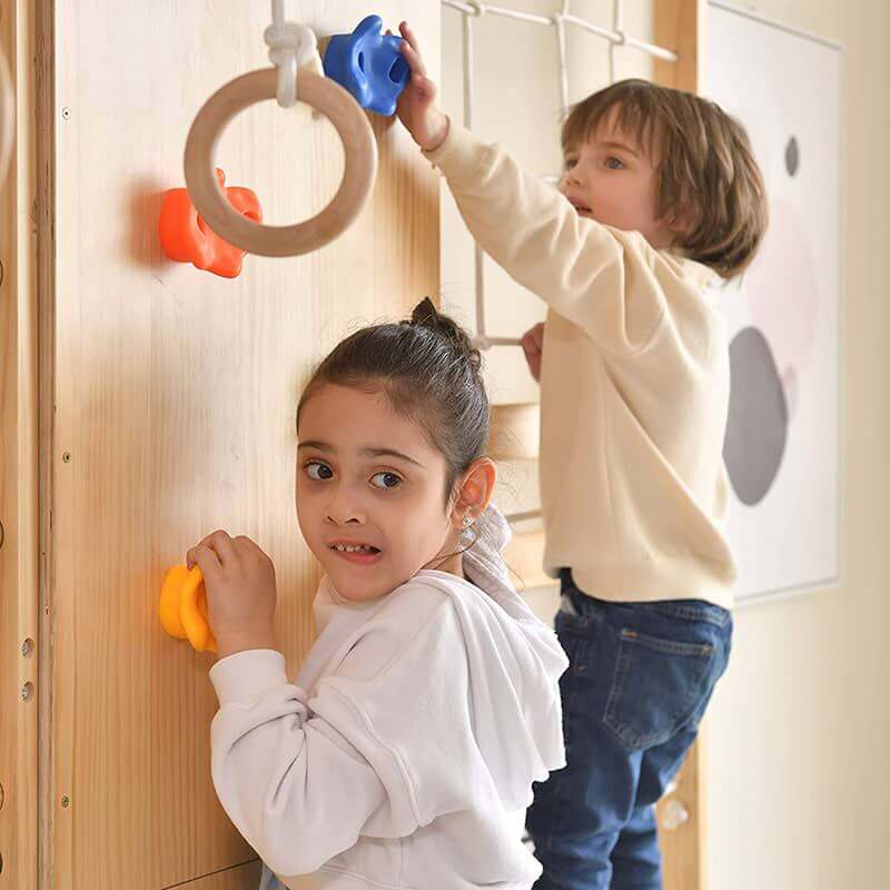 Avenlur Walnut - 9-in-1 Swedish Ladder Wall Gym Set Side View Up Close Of Kids Climbing Rockwall