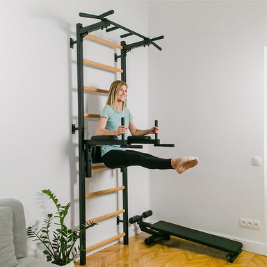 BenchK Dip Bar for Wall Bars DB1B with a women doing an ab workout