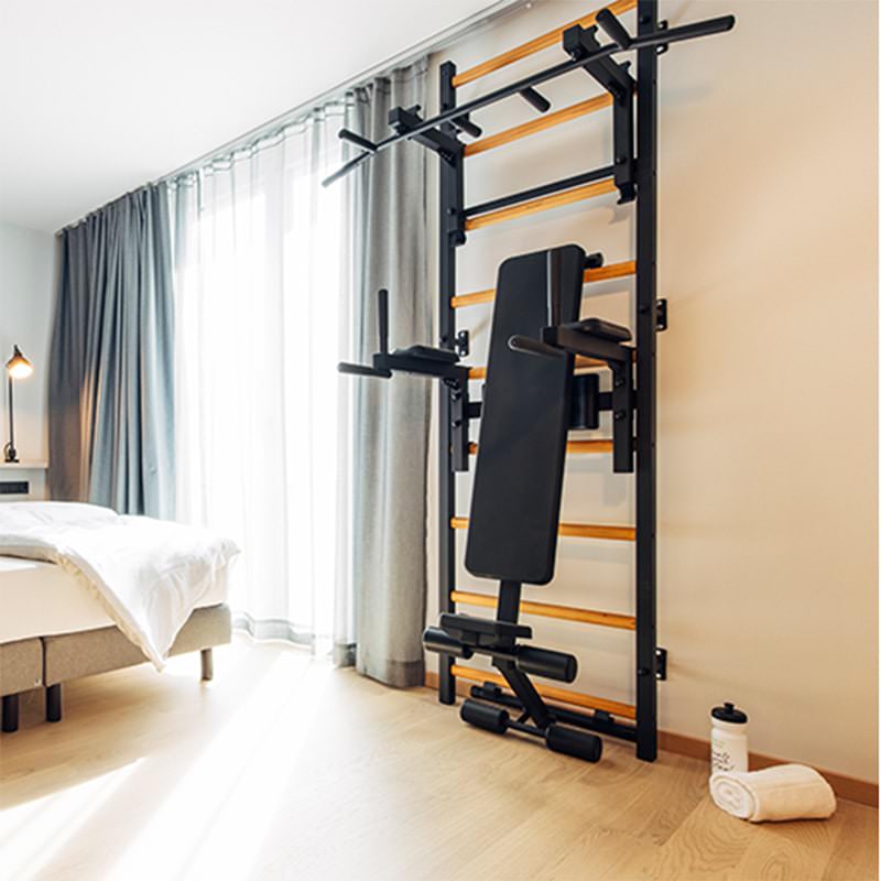 BenchK Wall Bars 733 for Home Gym Black Front Side View On Bedroom Workout Bench Folded