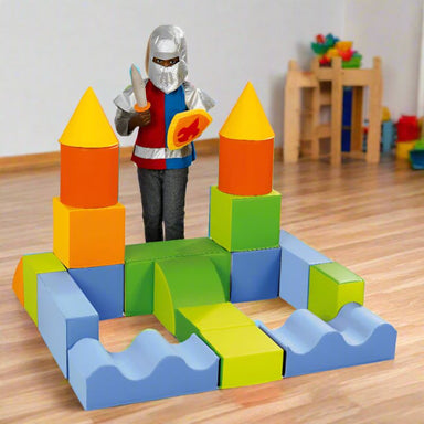 Giant Foam Building Blocks (Ludokit) in multi colors made in to a castle with a boy playing