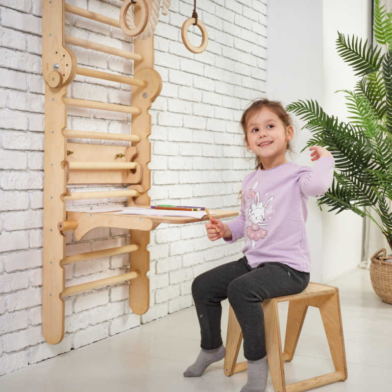 Goodevas 5 in 1: Wooden Swedish Wall Bar Set for Children with a girl doing her homework