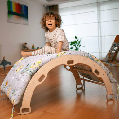 Kidodido Climbing Arch Rocker With Pillow Showing A Kid On Top Of The Rocker