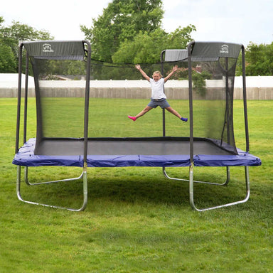 Skywalker Trampolines 16 ft Square Premium Colossal Trampoline with Enclosure(SPTCS16) and a blue spring pad with girl jumping