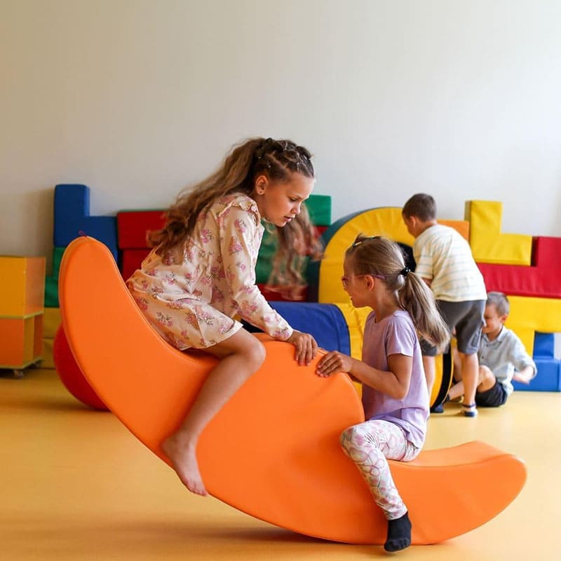 soft play rocker in orange with kids playing