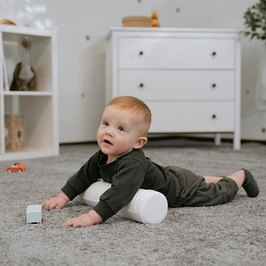 tummy_roller_white_toddler_rolling_in_bedroom