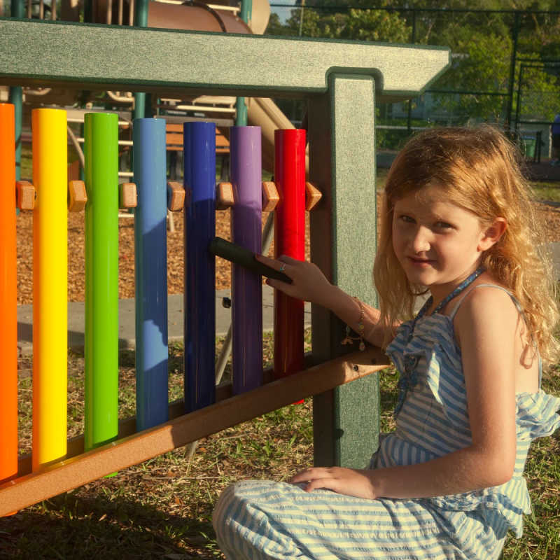 Playground Musical equipment in a park with a girl playing 