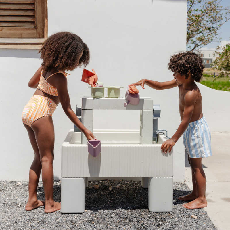 Sensory table with kids playing with water
