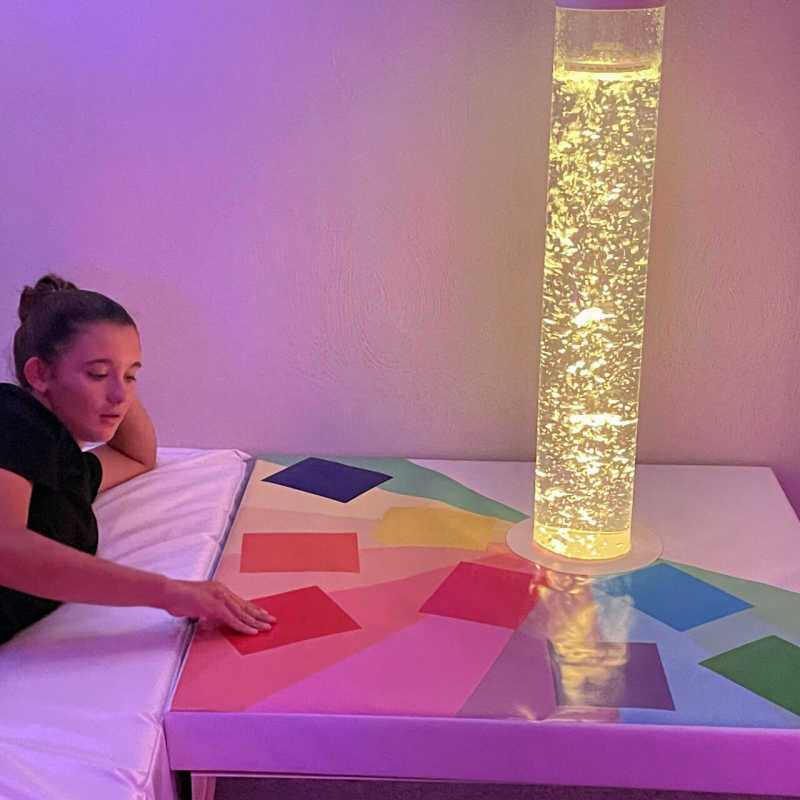 Bubble tube accessory touch a color podium with girl playing