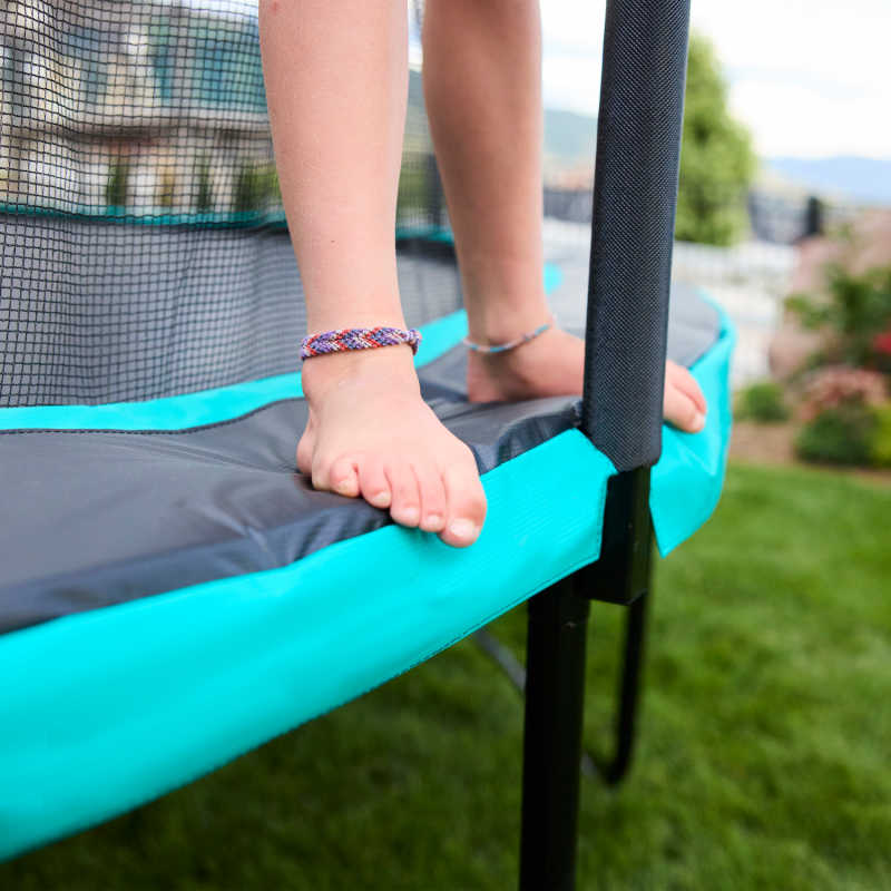 12' Round Skywalker Trampoline Net enclosure with girl