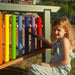 Girl playing commercial Playground equipment at a park