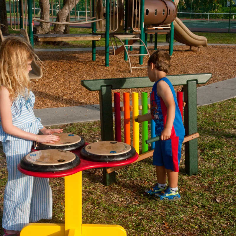 2 kids playing the 8 note rainbow musical commercial playground equipment and drums