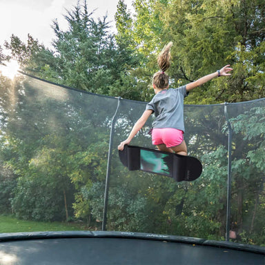 ACON Trampoline Skateboard with a girl jumping 