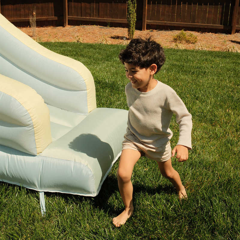 All-Star Sports Arena Bounce House with a boy by the slide