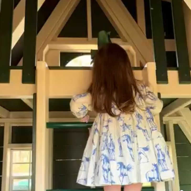 Vinyl Playhouse with slide with girl playing inside