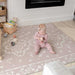 The August Rose Sand Shwally Playmat with baby
