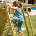 Child climbing the ladder on the Chestnut 8-in-1 Indoor Jungle Gym