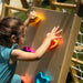 Child climbing the Chestnut 8-in-1 Indoor Jungle Gym rock wall