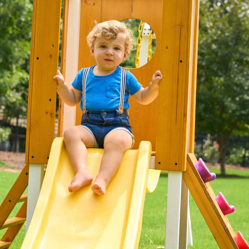 Avenlur Forest Small Toddler Outdoor Playset with kid on slide