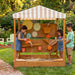Outdoor water play with a covered roof and kids playing 