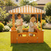 Avenlur Sumac outdoor wooden play market and mud kitchen with kids playing