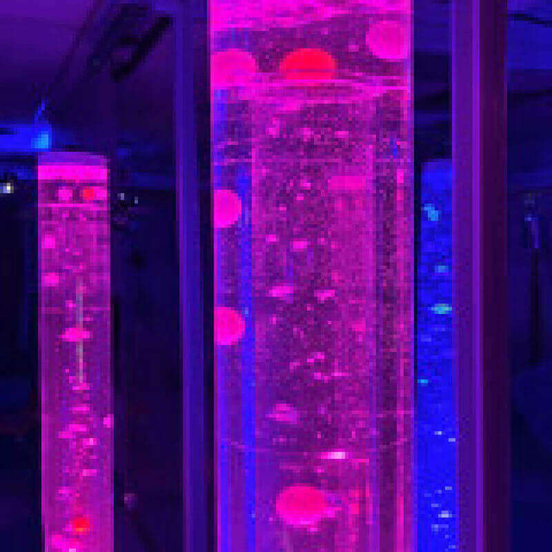Balls and Beads Inserts for Bubble Tubes Illuminated With Vibrant Pink and Blue Lighting