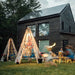 Bijou Build Mainstay outdoor playset teepee in the evening with the solar lights on