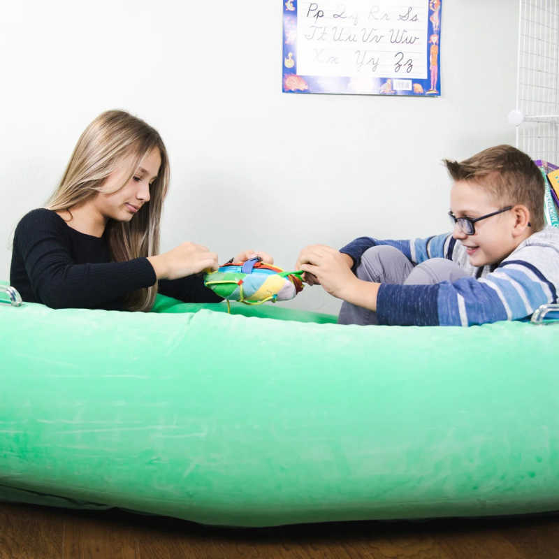 Kids using a mint green BouncyBand Comfy Hugging Peapod Large