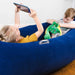 Kids relaxing in a dark blue BouncyBand Comfy Hugging Peapod Large