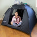 Girl sitting inside the BouncyBand Pop-Up Portable Sensory Dark Den