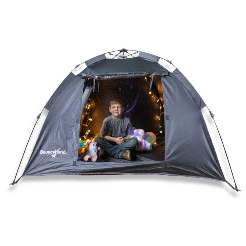 Kid relaxing inside the BouncyBand Pop-Up Portable Sensory Dark Den