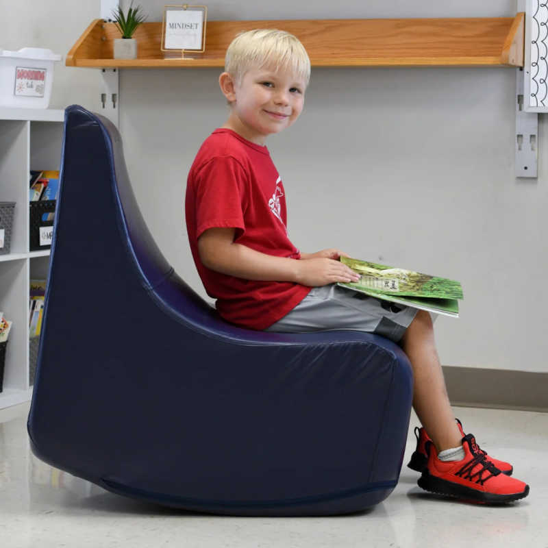 Boy using the BouncyBand Rocking Soft Sensory Chair in a sensory room
