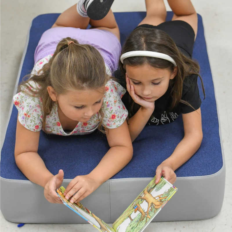 Two girls playing together on the BouncyBand Bouncy Pad