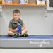 Boy sitting on the BouncyBand Bouncy Pad for flexible seating