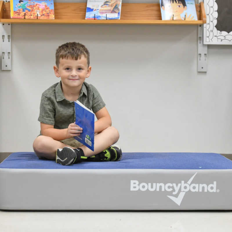 Boy sitting on the BouncyBand Bouncy Pad for flexible seating