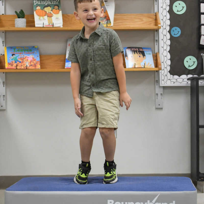 Boy jumping on the BouncyBand Bouncy Pad during an active movement break