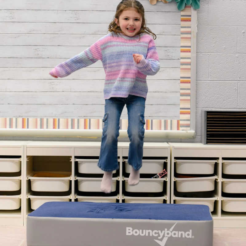 Girl using the BouncyBand Bouncy Pad in a sensory room
