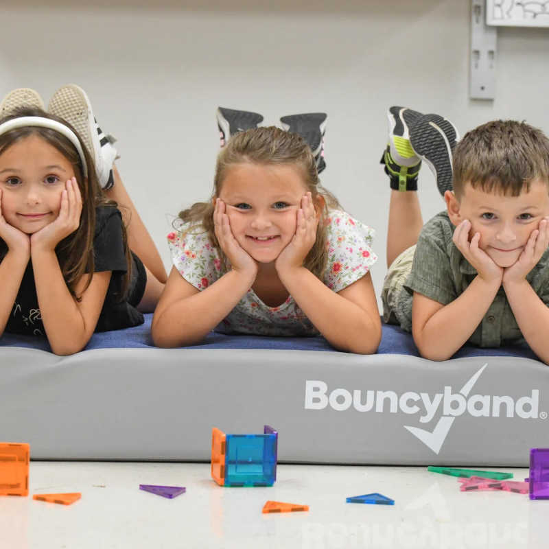 Two kids using the BouncyBand Bouncy Pad for indoor sensory movement play