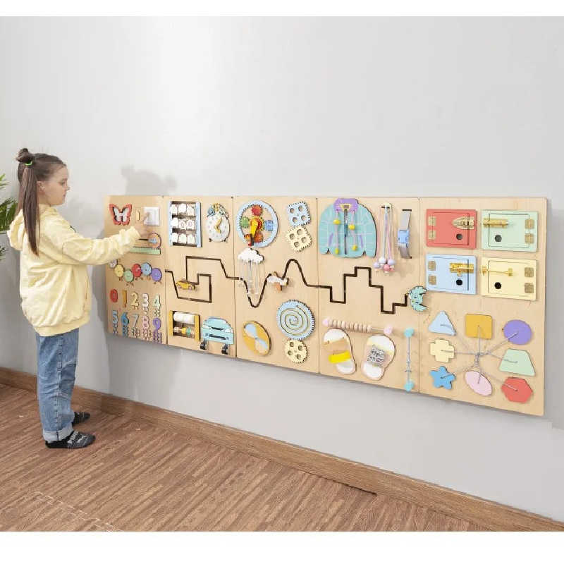 girl playing with sensory wall panel busy boar