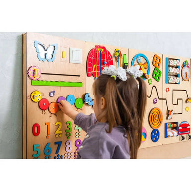Sensory Play Wall with a girl playing with the catepillar