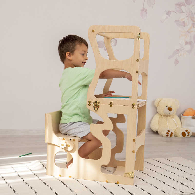 Wood and Hearts Convertible Kitchen Tower with a boy writing