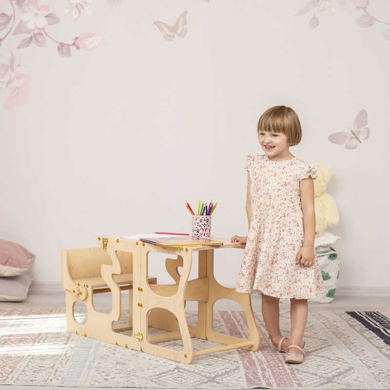 Wood and Hearts Convertible Kitchen Tower with a girl and her homework