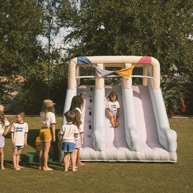 Double Slide Kids Inflatable with kids in a yard