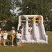 Double Slide Kids Inflatable with kids in a yard