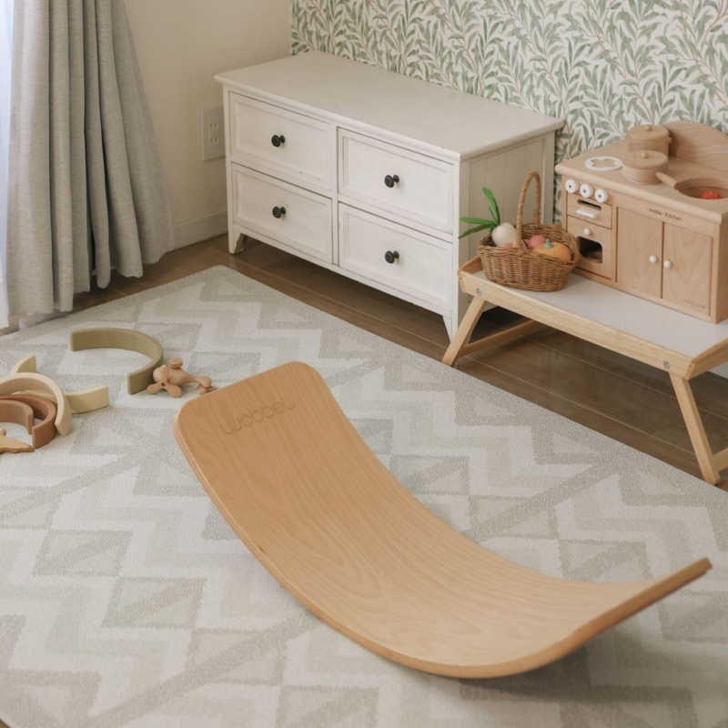 Eeveve Kilim Feather Gray Play Mat with a balance board on it