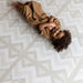 Eeveve Kilim Feather Gray Play Mat with a baby
