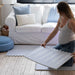 Eeveve Lucio Nordic Mist Play Mat with a mom putting it together