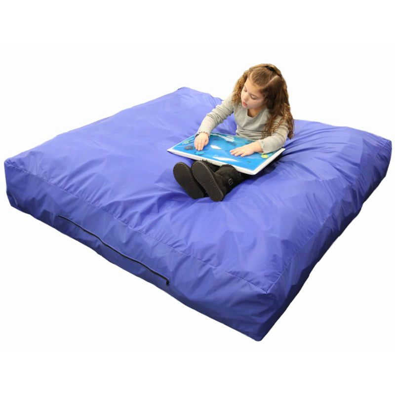Child sitting on the Enabling Devices Crash Pad with a sensory activity board